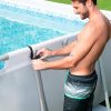 Man attaching Bestway swimming pool resistance trainer to pool frame